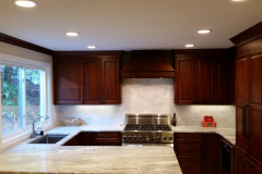 Cherry Cabinets with Marble backsplash and Marble Countertop