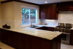Cherry Cabinets with Marble backsplash and Marble Countertop